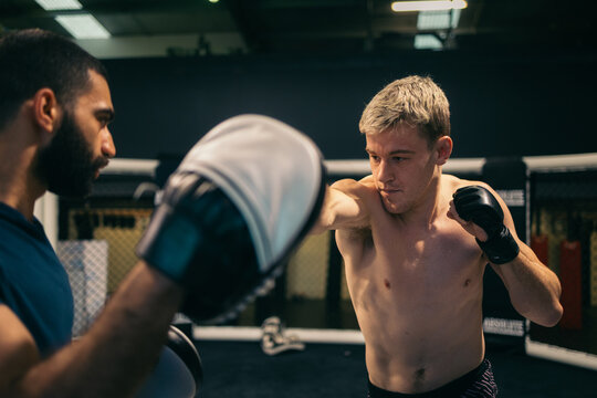 MMA fighter landing precise punches in MMA gym