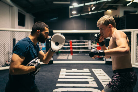 MMA session with athlete practicing pads
