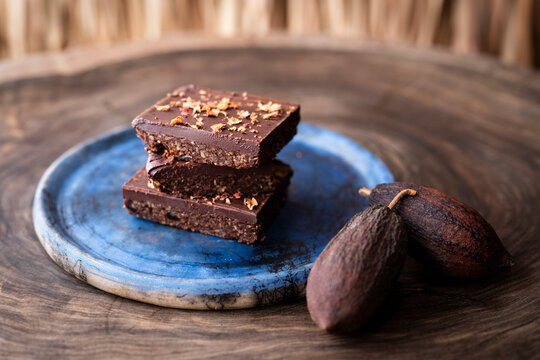 Stack of Brownies on a plate with a caco pod