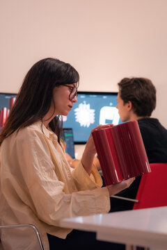 Woman studying 3d object at design studio