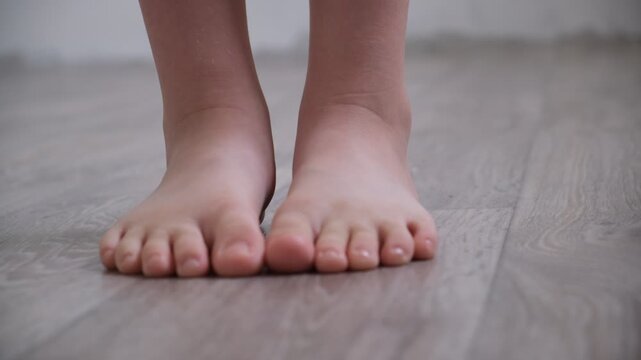 Barefoot teenage girl, dancer artist standing on tiptoe. Low section. Dance studio, tiptoe legs, position, practicing in ballet studio. Contemporary	