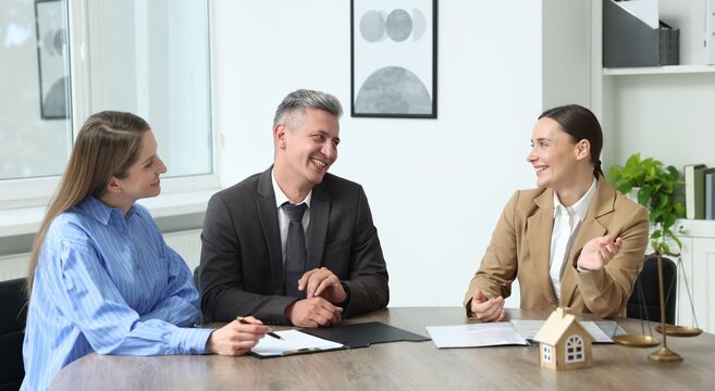 Notary working with clients at table in office