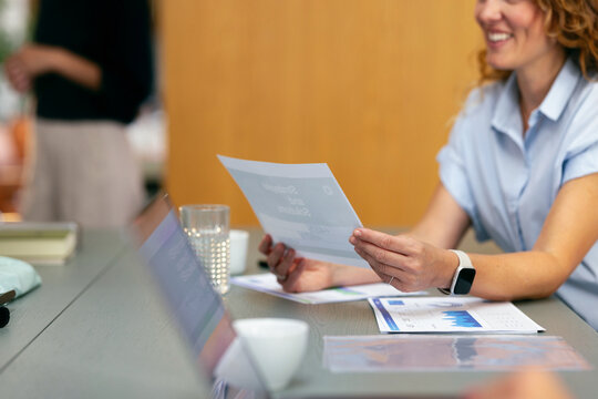 Business Meeting With Smiling Woman Reviewing Documents