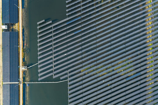 vast floating solar farm and wind turbines over water