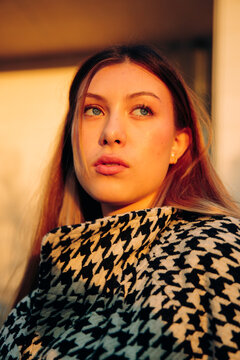 Young woman gazing away in sunlight