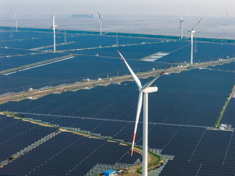 vast floating solar farm and wind turbines over water