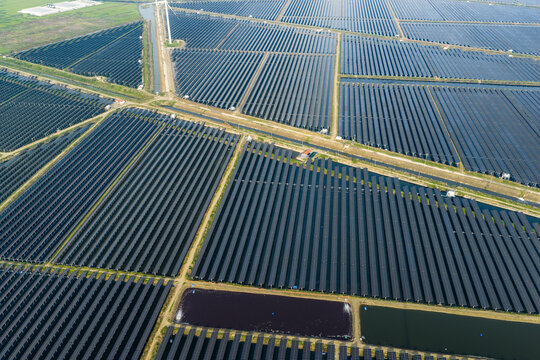 vast floating solar farm and wind turbines over water