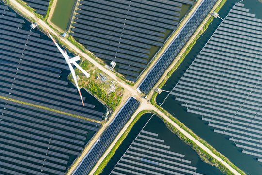 vast floating solar farm and wind turbines over water