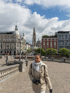 Female tourist with camera exploring Antwerp city center