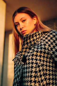 Young woman looking down at camera