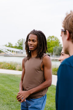 Athletic young man chatting with his group of fitness friends