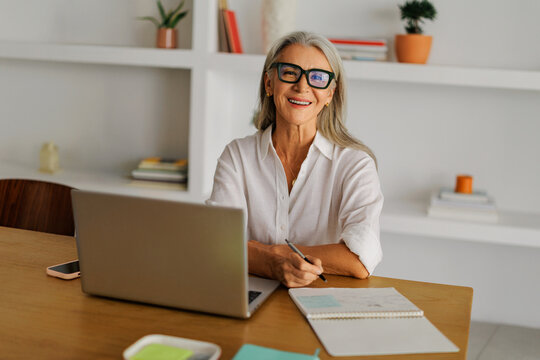 Mature woman working from home with laptop