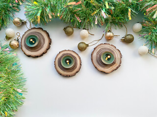 A Christmas arrangement with candles on wooden spires and tinsel. © fotorybalka