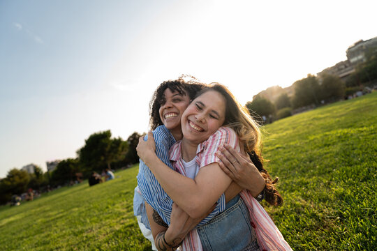 Happy Friends Hugging Outdoors