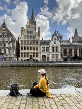 Woman Tourist Sitting by Waterfront with Copy Space in Ghent Belgium