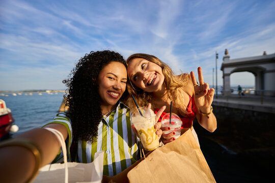 Happy young women taking a selfie on coastal vacation