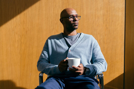 Businessman Holding Coffee Cup in Office