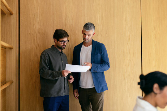 Two Colleagues Reviewing Documents During Business Meeting
