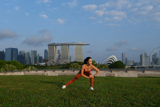 Woman stretching before workout in Singapore
