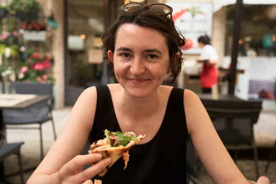 Eating a Pizza in a Restaurant With Flowers