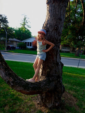 Young girl climbing a tree
