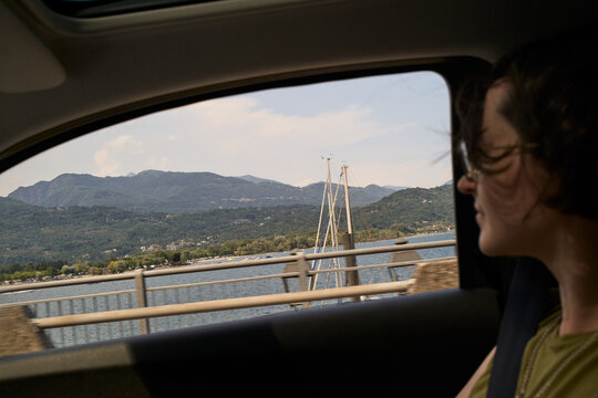 Driving Past a Lake With Mountains on the Side