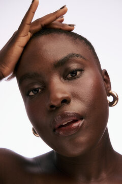 Close-up Shot of a Person With Short Hair and Earrings