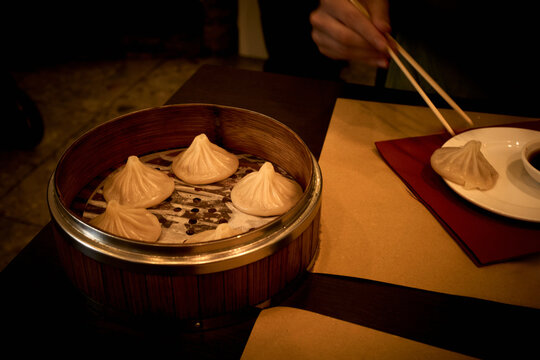 Dumplings on Display at a Restaurant With Chopsticks and Sauce
