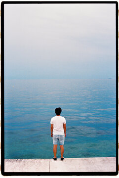 Man standing contemplating horizon