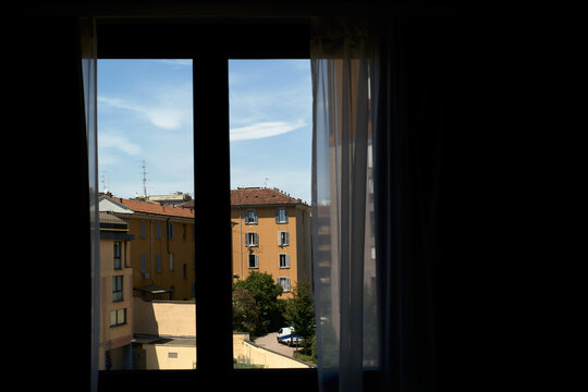 View From a Window Showing Buildings and a Clear Sky