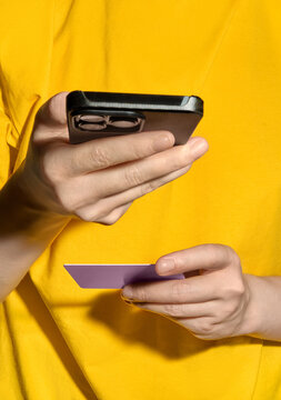 Person Using Smartphone and Credit Card for Online Payment