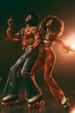 Happy African American Couple Roller Skating and Dancing at a Retro 1970s Roller Disco Party