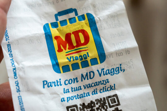Warsaw, Poland - Sep 5, 2026: MD Viaggi travel agency logo printed on a paper receipt held in hand indoors