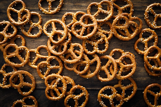 Oktoberfest Pretzel mini salted crunchy brezel snack crackers scattered on dark wooden background table