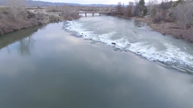 River flows rapidly over rocks creating white water and turbulence
