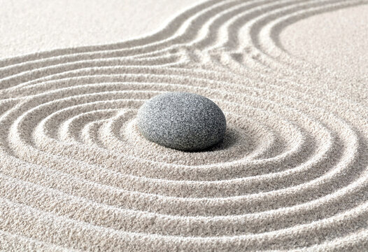 Zen garden sand pattern with a single smooth stone creating peaceful concentric circles