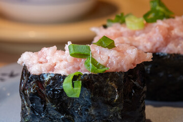 Pair of negitoro gunkan maki sushi topped with minced fatty tuna and green onions. © KAI-CHIEH YANG