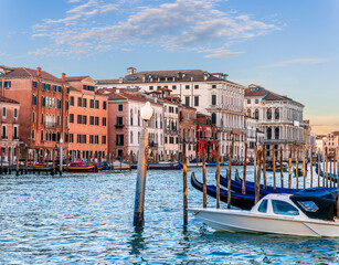 romantic view of a canal in Venice with boats and blue water and beautiful vintage buildings around the cityscape © Yaroslav