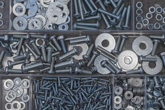 Various nuts, washers and bolts in a plastic box with compartments