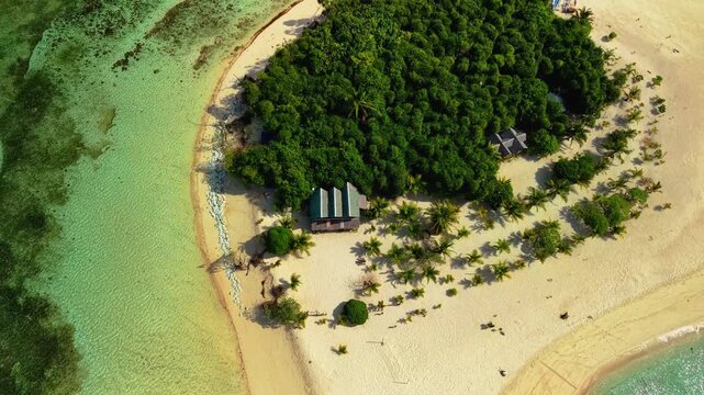 Aerial drone footage of Inaladelan Island in Port Barton, San Vicente, Palawan, Philippines, showcasing its white sand beach, crystal-clear turquoise waters and lush tropical landscape.