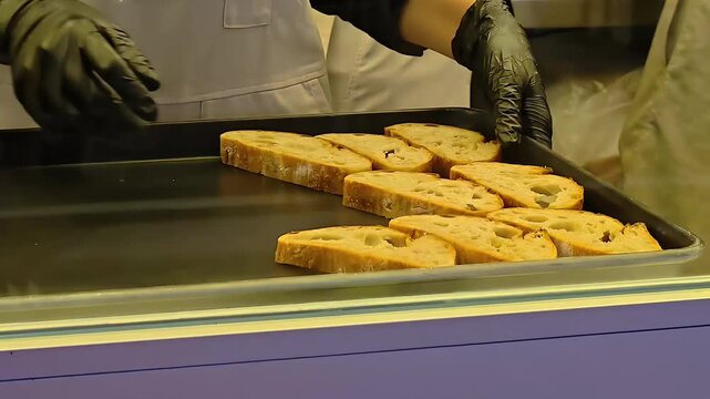 Chef laying sliced rye sourdough bread on rack, Food Preparation, Baked Pastry, Bakery Kitche, Loaf Slices, Healthy Diet