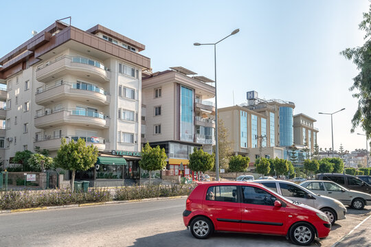 Street scene on Stad Cd in Alanya with cars parked near Yemen Kahvesi cafe and Anadolu Hospital. Horizontal view of urban medical and retail area. Alanya, Turkey - October 25, 2020