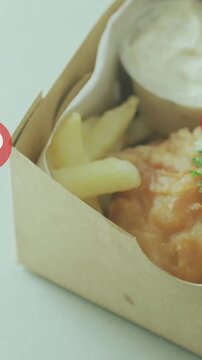 Heart icons animation over fish and chips in takeaway box