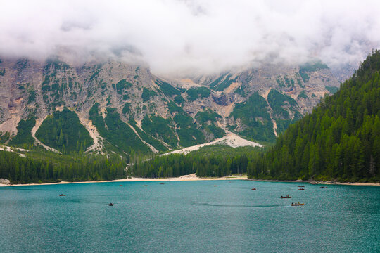 Mountain lake in blue and green colors close up. Touristic hiking adv. Colorful summer view of Braies Lake ( Pragser Wildsee ) in Dolomites. Traveling concept background. Tour touristic close up. 