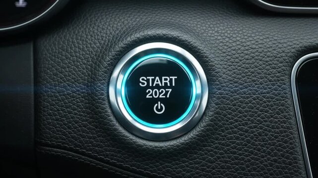 Finger pressing glowing car engine start button with 2027 text. New year future concept