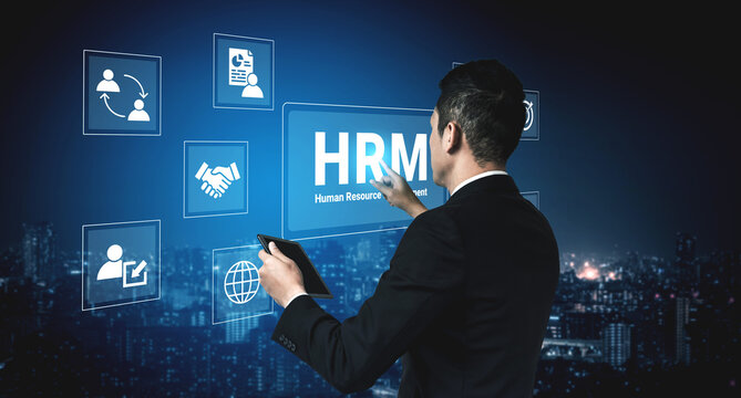 A business professional interacts with a human resource management interface in a modern digital environment, showcasing innovation and strategy against a city skyline backdrop. Cyphers