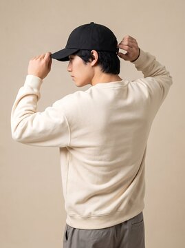 Rear View of Man Adjusting Black Baseball Cap Wearing Off White Sweatshirt Mockup