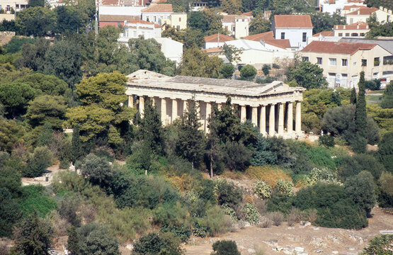 Elevated panoramic view of the Temple of Hephaestus surrounded by lush trees in Ancient Agora, Athens