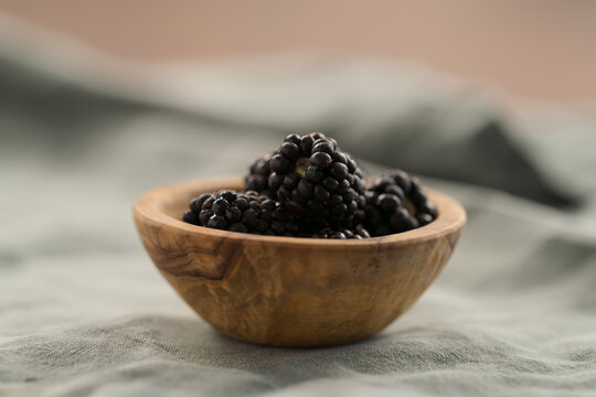fresh ripe blackberry in a small wooden bowl