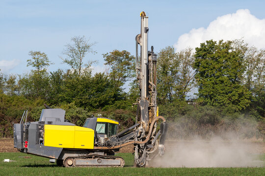 Brutal power for clean energy. A mobile drilling rig kicks up dust while preparing the field for the photovoltaic future.